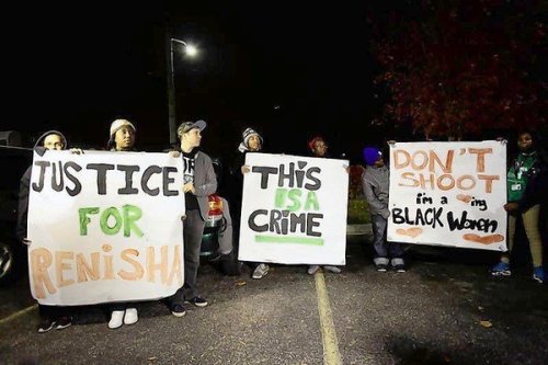 Demonstrators protest the killing of 19-year-old Renisha McBride outside the Dearborn Heights Police Station