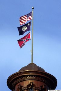The Confederate flag flies on the dome of the Statehouse in Columbia, S.C., Friday, June 30, 2000. The flag will come down from the dome during a ceremony Saturday along with Confederate flags that fly in the House and Senate chambers. (AP Photo/Eric Draper)