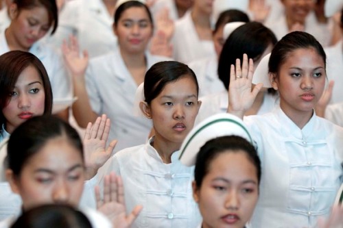 New Filipino nurses during an oathtaking ceremony in Pasay city, south of Manila, Philippines on 20 September 2010. A total of 37,679 out of 91,008 examinees passed the Philippine Nurse Licensure Examination held on July 3 and 4. Work opportunities for Filipino sailors, nurses and engineers are growing as the global economy recovers from last year's slump. EPA/DENNIS M. SABANGAN
